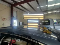PDR light on car hood - repairing hail dents on car hood.